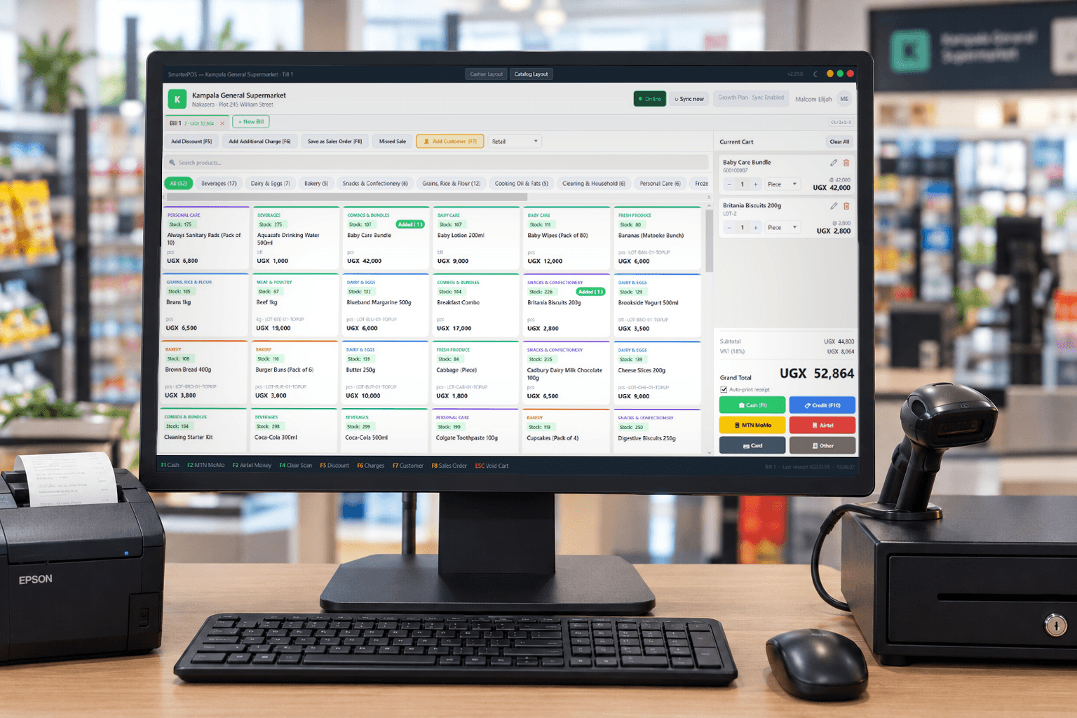 SmarterPOS till on a laptop: product catalog with stock and batch lots, cart with customer, and payment buttons for cash, MoMo, Airtel Money, and card